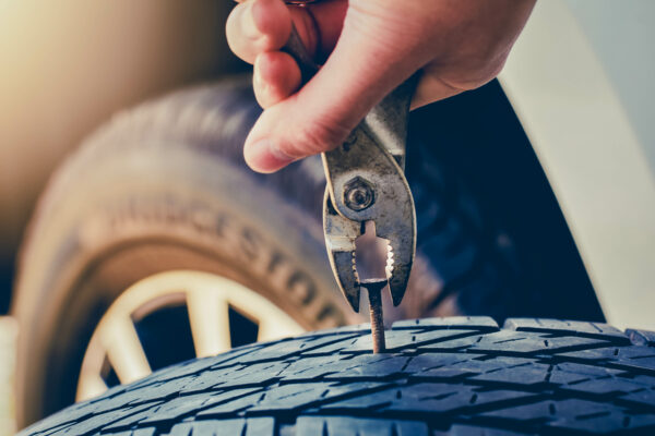Hand Pulling For Removing A Nail In The Tire,flat Tire Fixing And Repair The Tire Is Leaking From The Tack